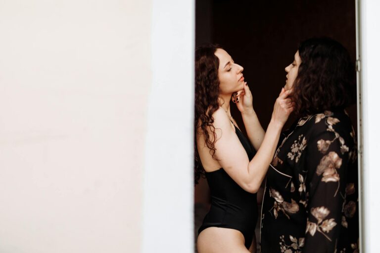 An intimate and romantic moment between two women indoors, expressing love and closeness.